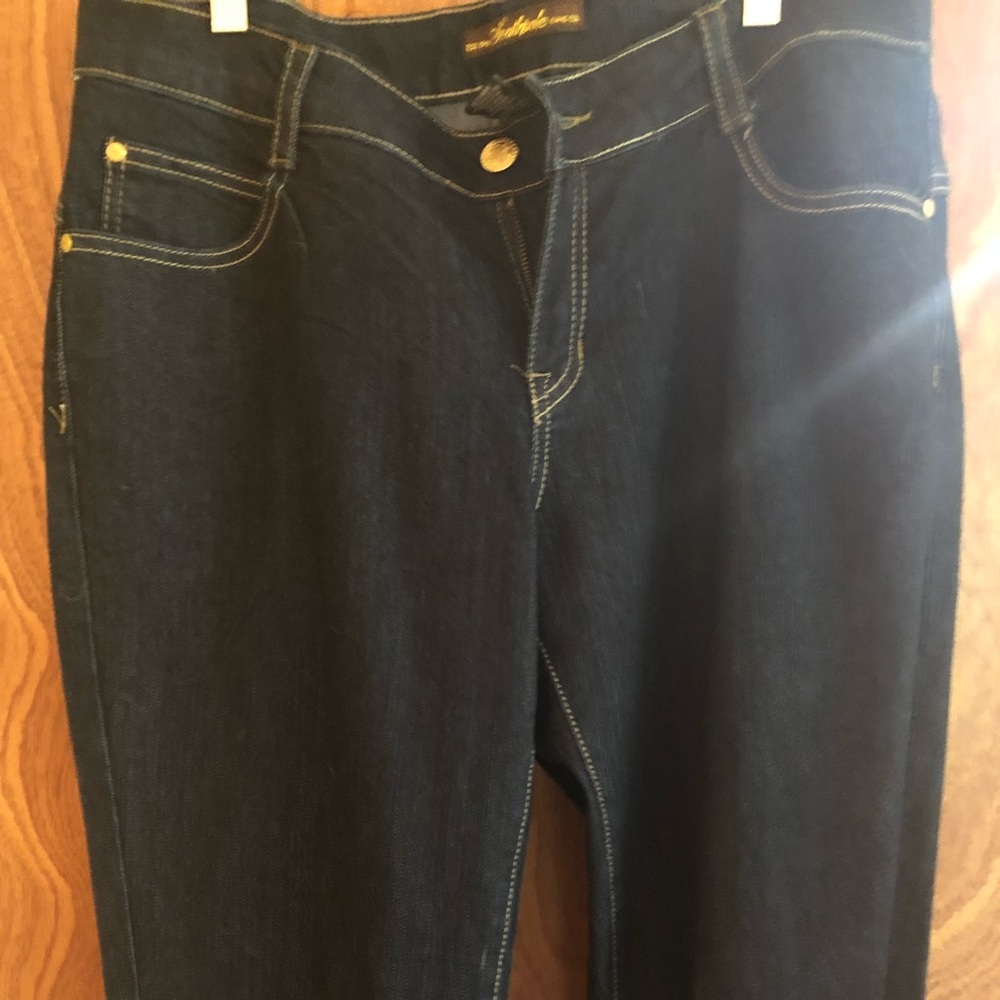 Denim jeans with gold embroidered pockets.